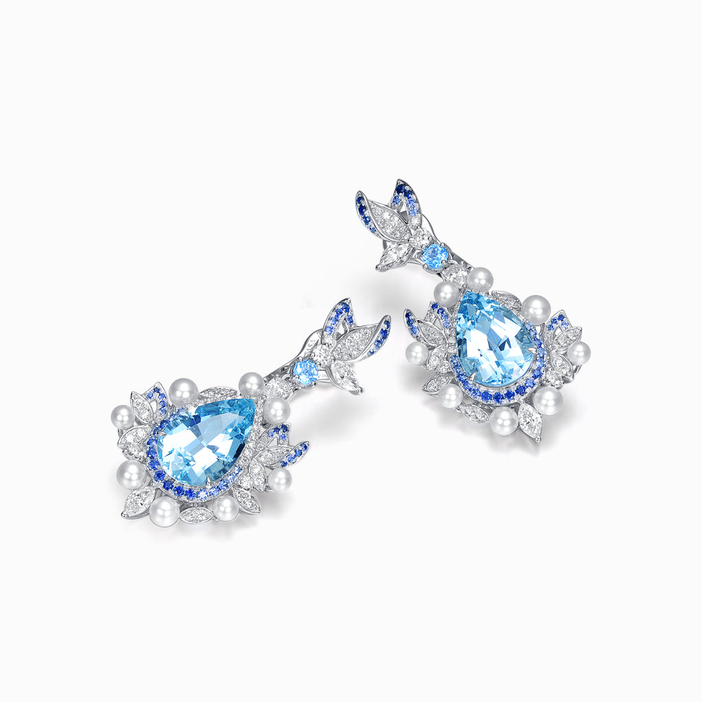 TASA natural aquamarine and blue sapphire drop earrings angled view, pear aquamarine with marquise diamond and pearl halo, 18K white gold