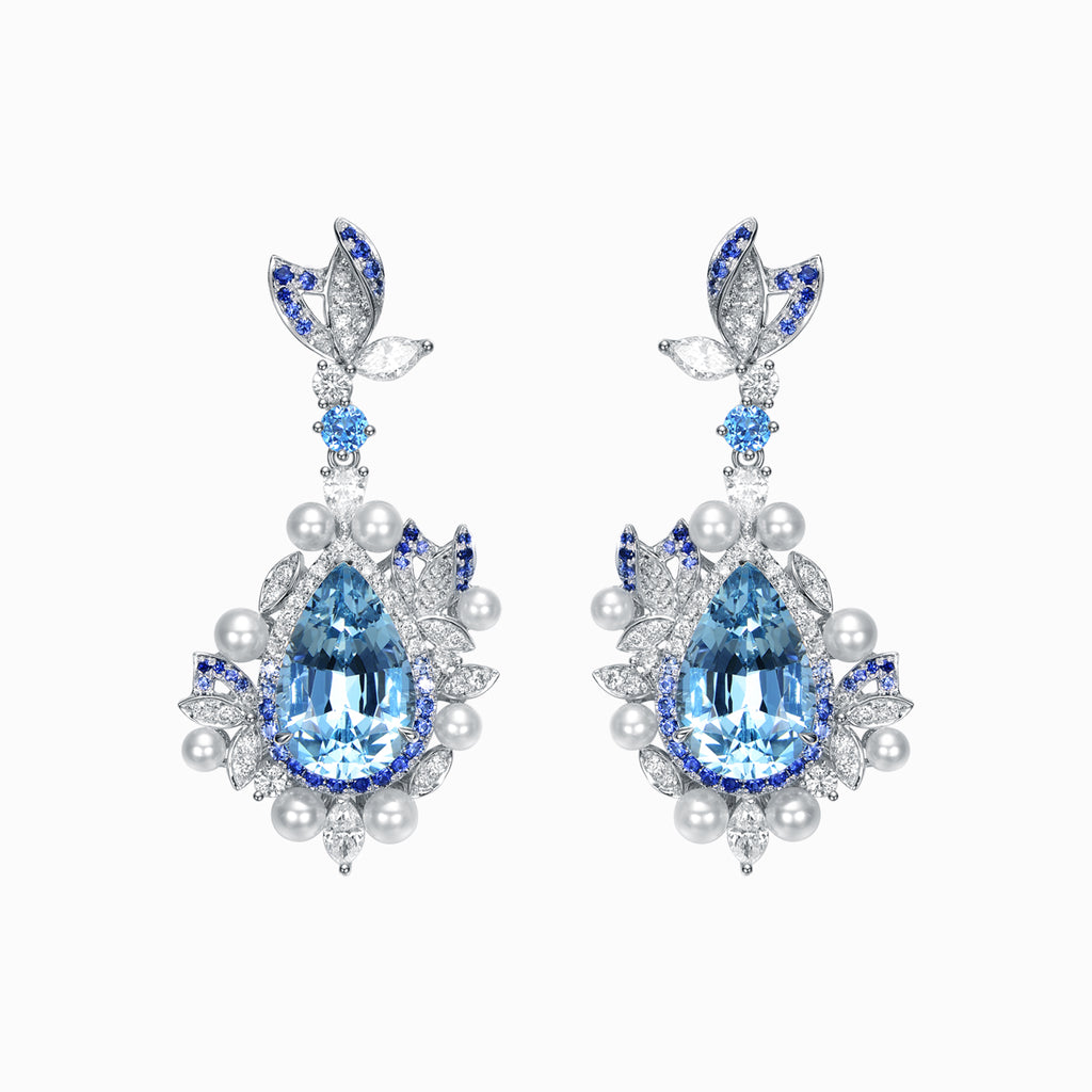 TASA 18K white gold drop earrings featuring 14.33ct pear-cut aquamarine with blue sapphire halo, diamond and pearl accents, front view on white background