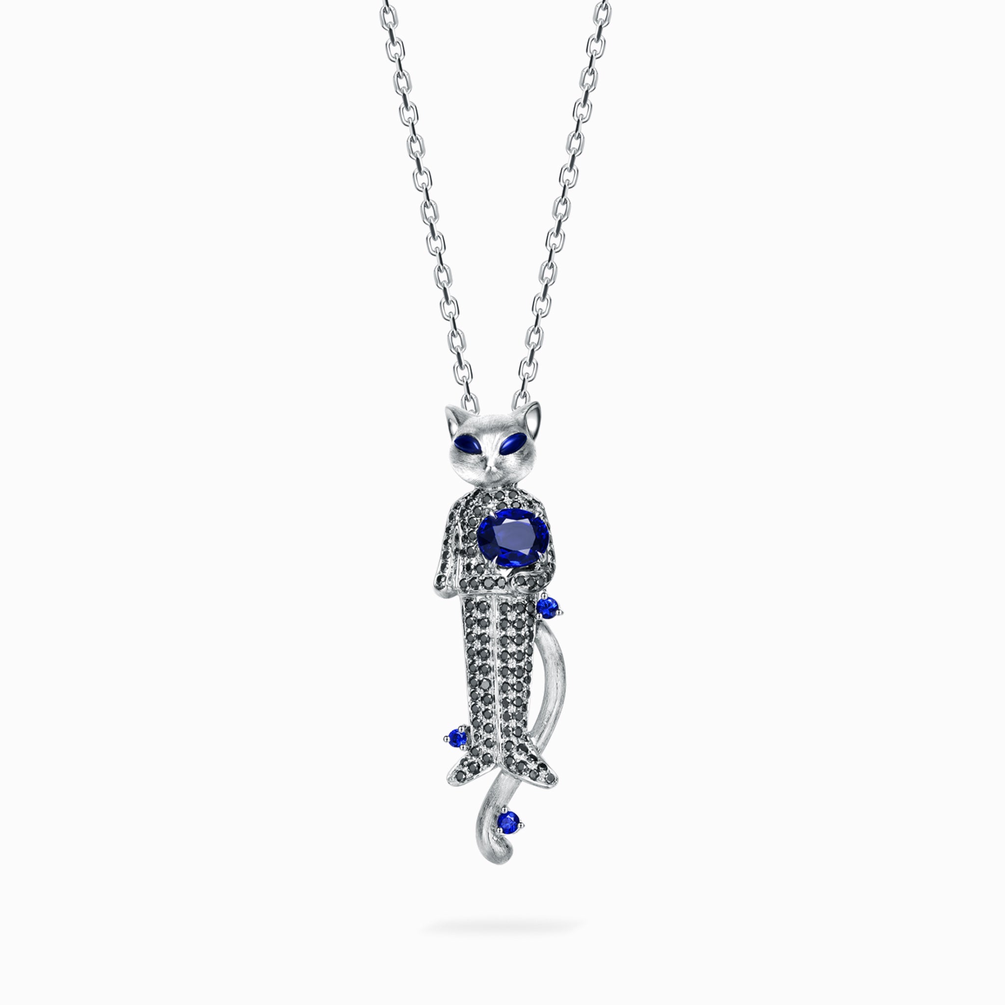TASA 18K white gold cat pendant necklace featuring 0.82ct natural blue sapphire with 108 black diamond pavé and sapphire accents, front view on white background