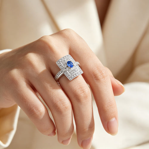 Close-up of hand wearing TASA 18K white gold blue sapphire and diamond Art Deco rectangular ring