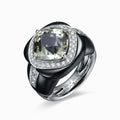 TASA 18K white gold ring featuring 8.14ct cushion-cut green tourmaline with diamond halo and sculptural black ceramic band, side view white background