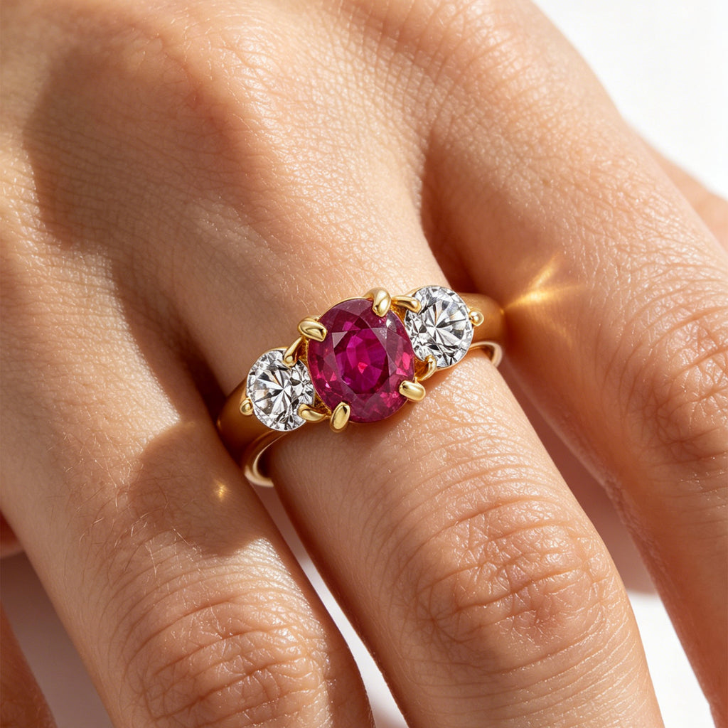 TASA 1.15ct natural ruby three-stone diamond ring worn on finger close-up, 18K yellow gold fine jewellery